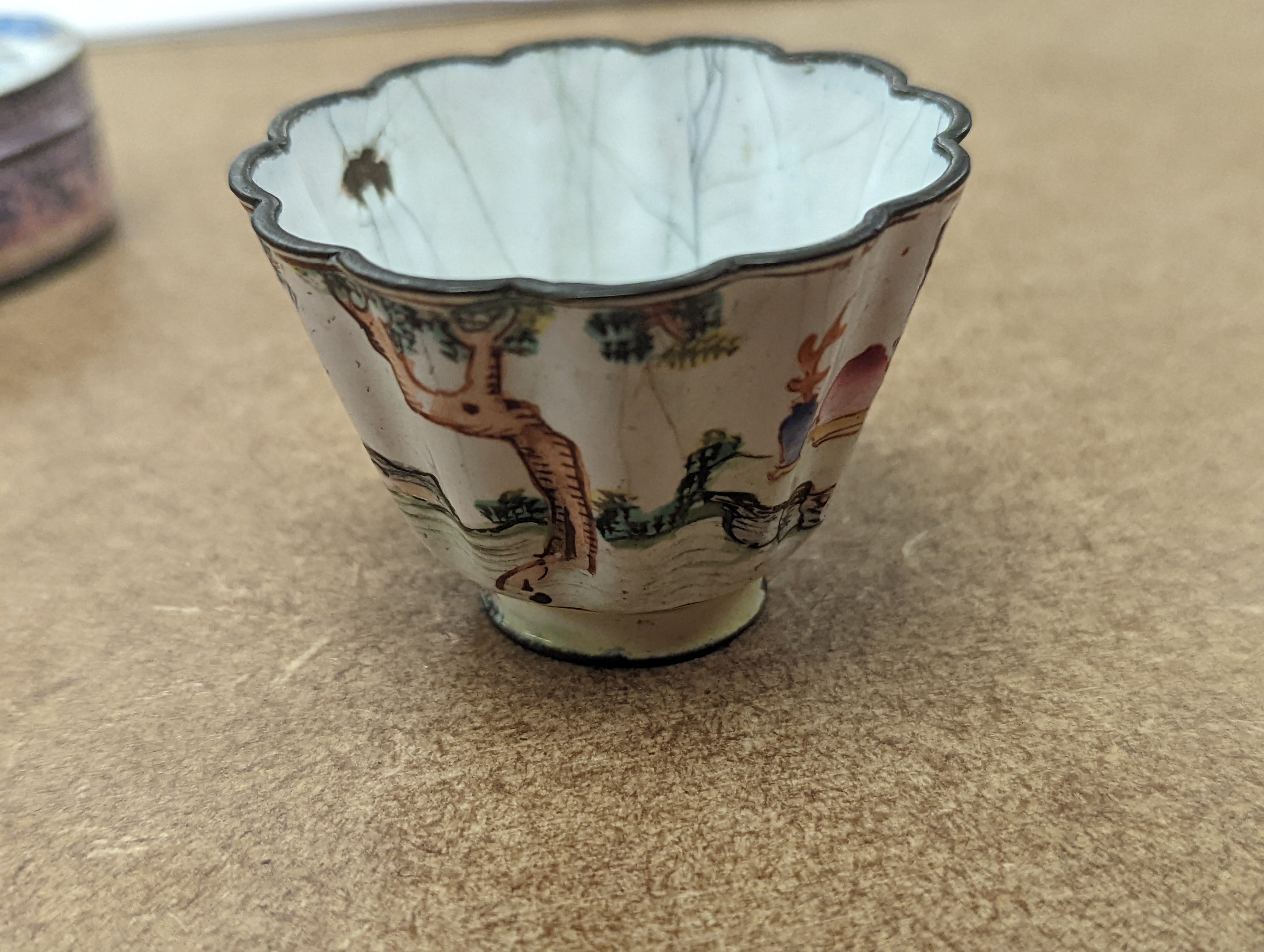 Two 18th century Chinese Canton enamel cups, and a 19th century Canton enamel oval snuff box, 5.8cm